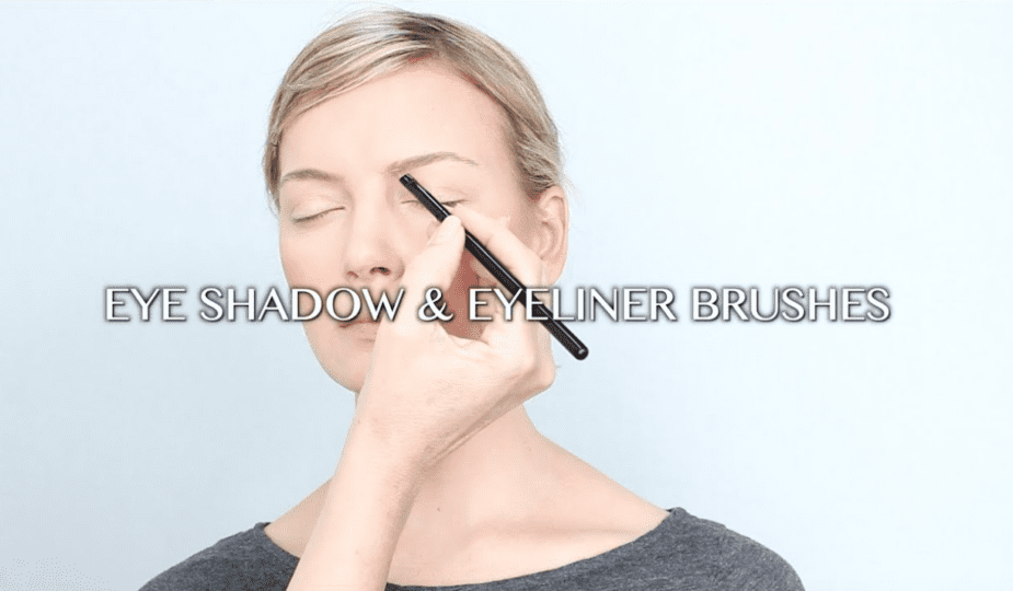 A woman with a black eyeliner brush.