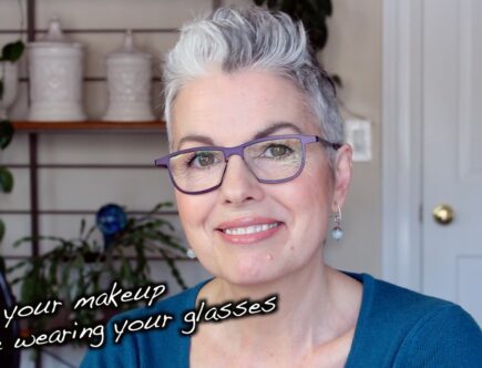 A woman with glasses smiling.