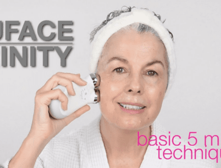 A woman using a NuFACE Trinity Microcurrent Device to remove her wrinkles.